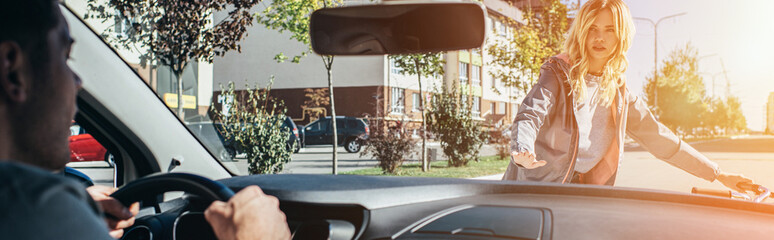 Wall Mural - young woman quarreling with car driver while crossing road