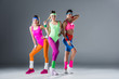 © LIGHTFIELD STUDIOS - attractive sporty girls in 80s style sportswear posing together and looking at camera on grey