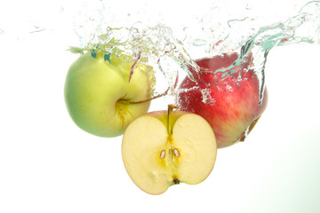 Apples and aple slice splash in water on white