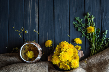 dandelion flowers on a black wooden table 2