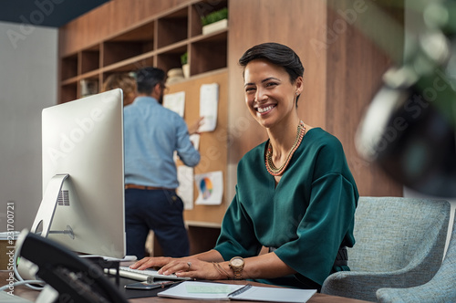 Plakaty do biura young-businesswoman-smiling-at-office