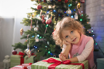  girl in a room with a Christmas tree