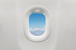 © charnsitr - Isolated airplane window with blue sky