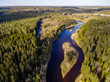 © Martins Vanags - drone image. aerial view of rural area with fields and forests with river and water reflections