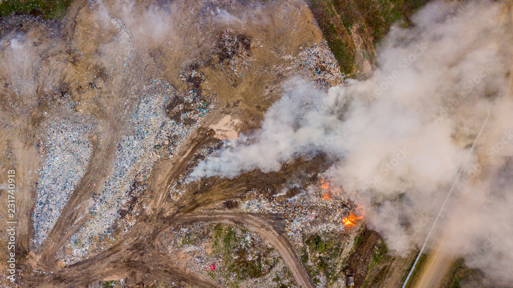 Aerial view of illegal landfill in the forest. Waste incineration ...