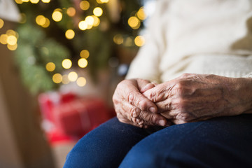 Poster - A close-up of a senior woman sitting at home at Christmas time.