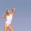 Fashion Vacation Girl in the blue sky.  Beach look. Vacation minimal style
