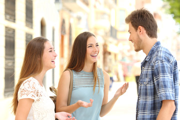 Wall Mural - Three smiley friends talking in the street