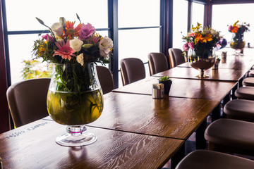 The interior has a long wooden table and leather chairs, a good place for business conferences, meetings, events and dinners for many people. On the tables of a vase with flowers, a terrace by the sea