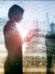 Wall Mural - double exposure gears mechanism on blurred background. business and industrial process automation co