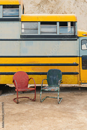 Two Metal Chairs Outdoors Against School Bus Kaufen Sie