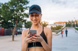 © Stocksy - Sporty young woman texting on her smartphone