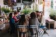 © Stocksy - People sitting and dining together