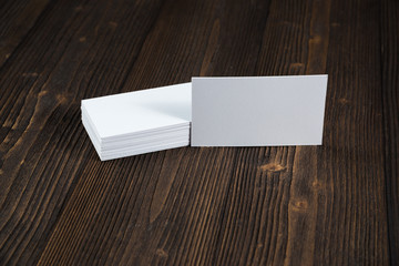 Blank business cards on wooden working table with copy space for add text ID. and logo, business company concept.