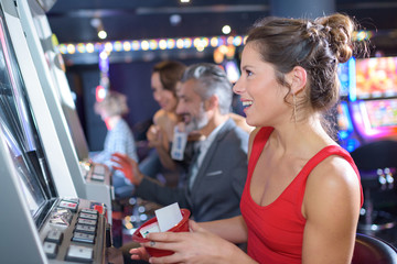 woman playing slot machines in the excalibur hotel and casino