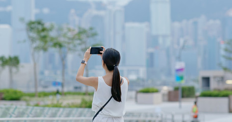 Canvas Print - Woman take photo on cellphone in Hong Kong city