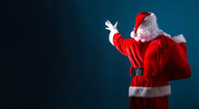 Santa Holding A Red Sack On A Dark Blue Background