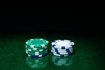 Casino games concept,Poker chips on gamble table , Light through background, winning hands of cards. gambling success