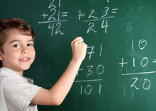 Young Student In Front Of Blackboard