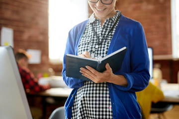 Sticker - Young casual manager making notes in notebook while preparing for seminar