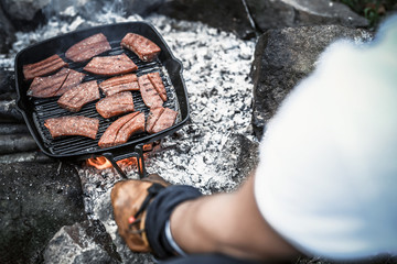 Wall Mural - Sausage over the bondfire in nature - selective focus