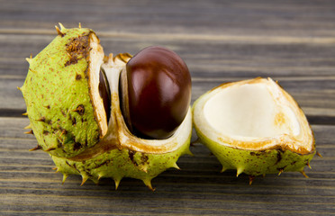 Wall Mural - chestnuts on a wooden table