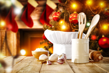 Wall Mural - Cook hat on table and christmas tree with fireplace 