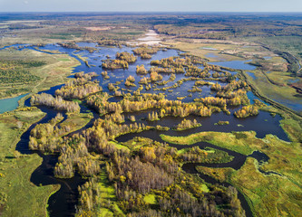 Aerial view of river after gold mining by dredge in Russia, Middle Urals, shot by drone