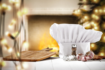 Wall Mural - White cook hat on white wooden table and christmas decoration. Free space for your products. 