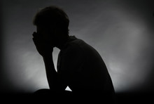 Silhouette Of Stressed Man On Dark Background