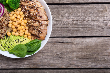 Wall Mural - Buddha bowl with broccoli , quinoa , grilled chicken , avocado and spinach