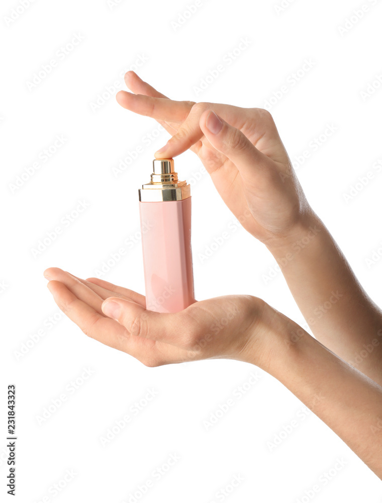 Woman holding bottle of perfume on white background