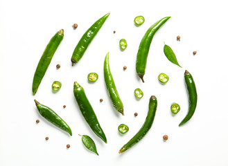 Flat lay composition with green chili peppers on white background