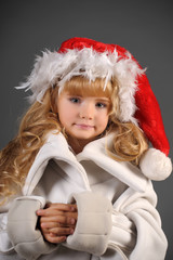 portrait of blonde girl in christmas hat with feathers,