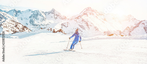 Cuadros en Lienzo Young athlete skiing in alps mountains on sunny day