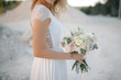 Bride with a beautiful wedding bouquet in light colors