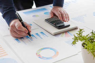 stock market chart and finger pointing on tablet in office