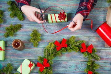 Wall Mural - Hands of woman decorating Christmas gift box