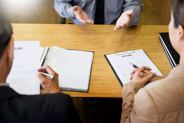 Wall Mural - young man explaining about his profile to business managers sitting in job Interview. listen to candidate answers Hiring employee, nervously clutched scolded by boss.