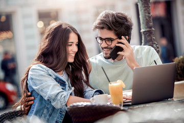 Wall Mural - Young couple in love sitting in cafe