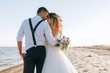 © Mykhailovskyi - bride and groom on the seashore. wedding concept on the sea, on a fabulous island.