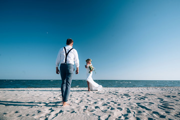 Wall Mural - Honeymoon Bride and Groom Relaxing By the Sea