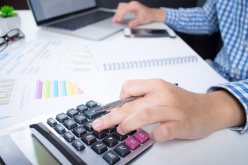 Poster - Side view of businessman wearing a shirt is calculating financial figures from the computer screen seriously.