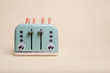 © George - Retro green 4 slice toaster on a vintage tan background with four slices of toast popping out