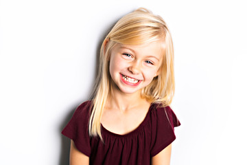 Wall Mural - A Cute girl 5 year old posing in studio