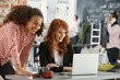 © Photographee.eu - African-american woman working with smiling businesswoman in marketing agency