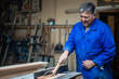 © Vladimir - Carpenter at work at his workshop, wood processing on a woodworking machine