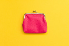 Pink Wallet On Yellow Background . Close Up. Top View
