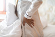 © 220 Selfmade studio - woman have a back and hip pain sitting on bed in bedroom feeling painful,Healthcare concept