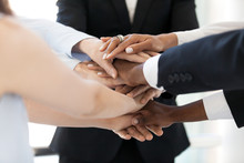 Close Up Of Diverse Employees Stack Hands In Pile Show Mutual Support, Multiethnic Workers Promise Loyalty And Help Involved In Team Building Activity, Team United At Motivational Business Training